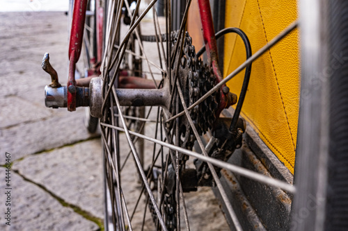 detail of vintage bike on stone paved road. gears