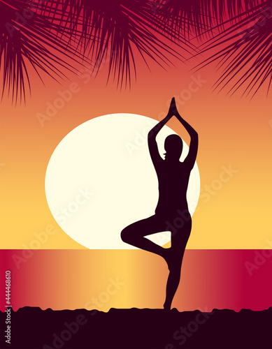 yoga girl meditates on the beach at sunset