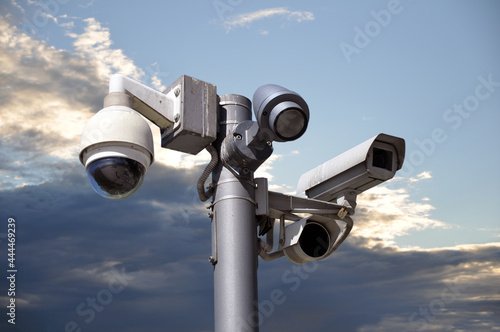 Many CCTV cameras on the background of the sky