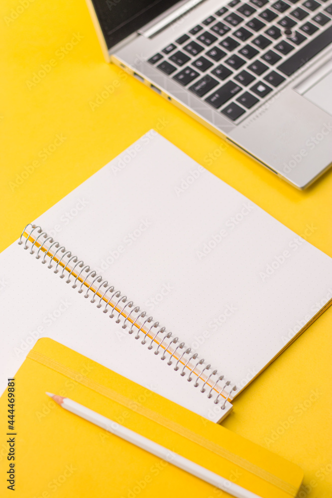 Empty notebook ready for mockup on yellow table, top view, flatlay. Empty notebook ready for mockup on yellow table, top view, flatlay.