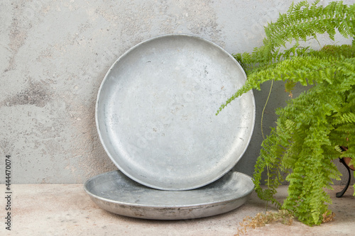 Old metal plates for scales on concrete background.