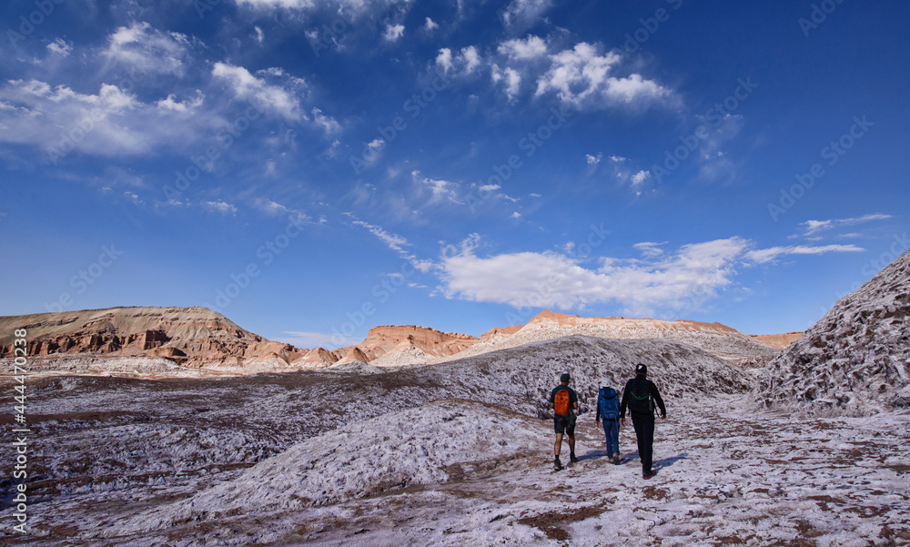 Trekking through the desert landscape in the Moon Valley, San Pedro de Atacama, Chile