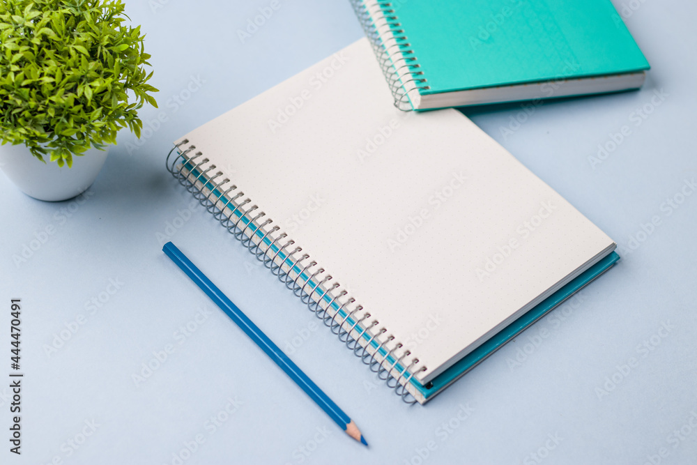 Empty notebook ready for mockup on blue table, top view, flatlay. Empty notebook ready for mockup on blue table, top view, flatlay.