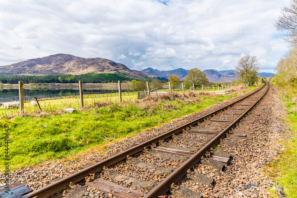 A view along the railway line beside Loch Eil near to Fort William, Scotland on a summers day