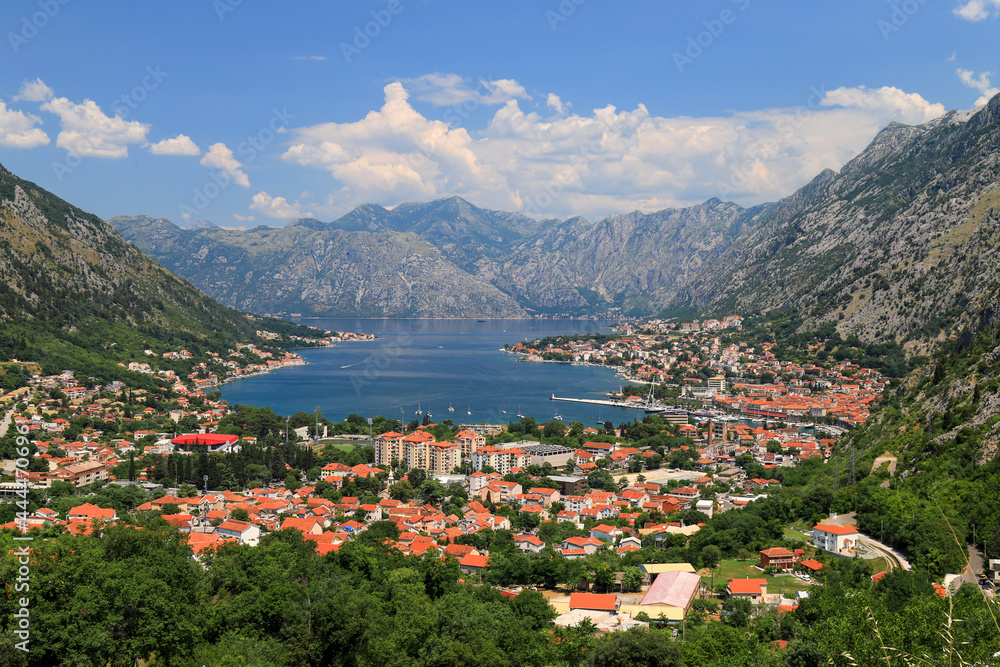 Fototapeta premium Full view of the beautiful Kotor Bay and the old city Kotor surrounded by high mountains in Montenegro in summer