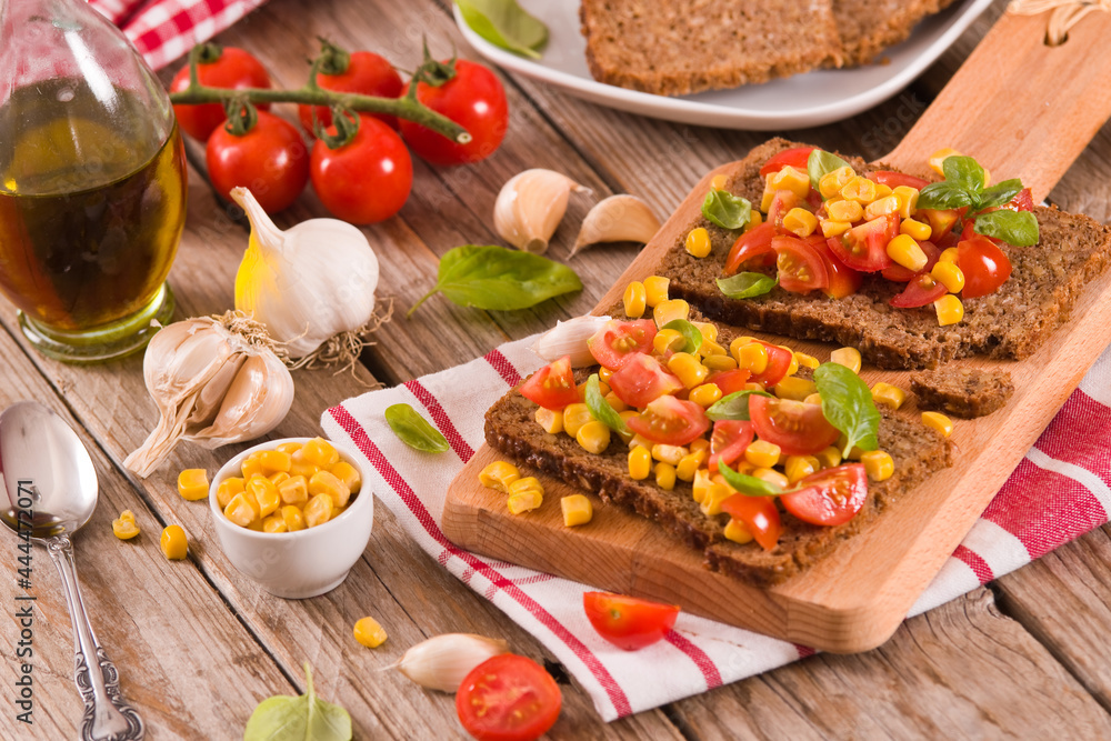 Rye bread withsweet  corn, basil and tomato.