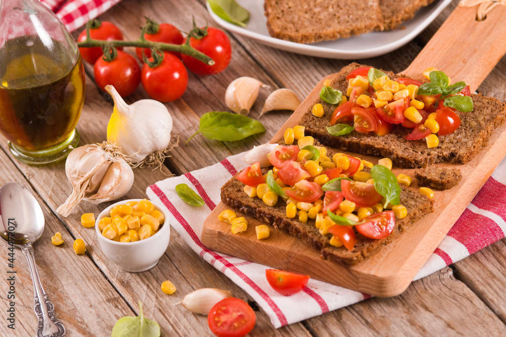 Rye bread withsweet corn, basil and tomato. Rye bread withsweet corn, basil and tomato.