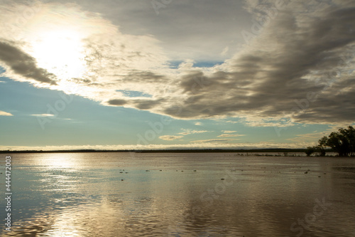 Magical sunset in the river. The sky reflection in the water surface. 