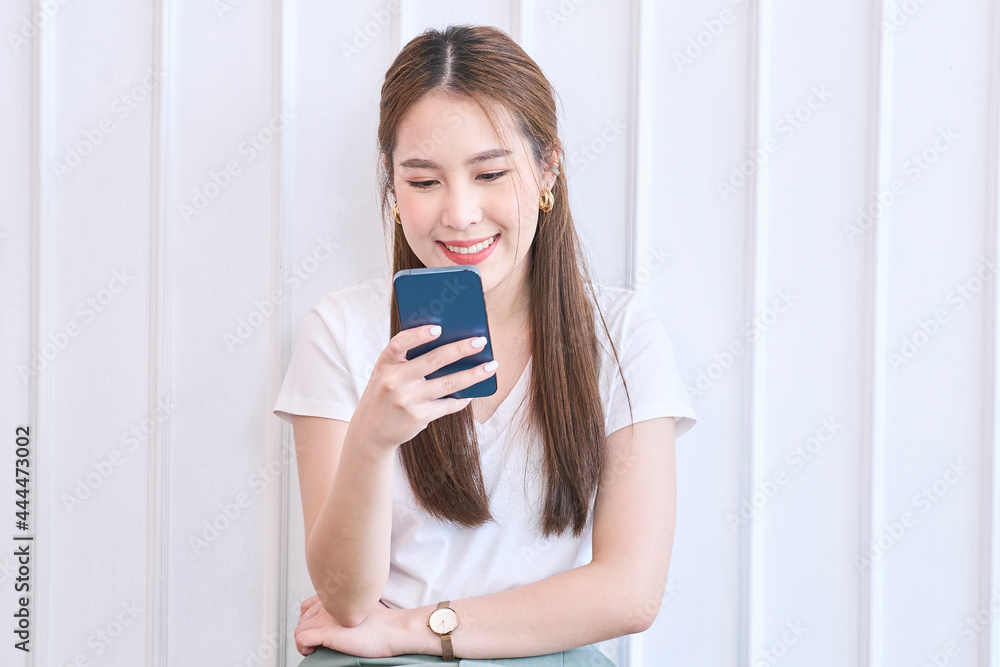 Photo of cheerful cute beautiful young woman chatting by mobile phone Photo of cheerful cute beautiful young woman chatting by mobile phone