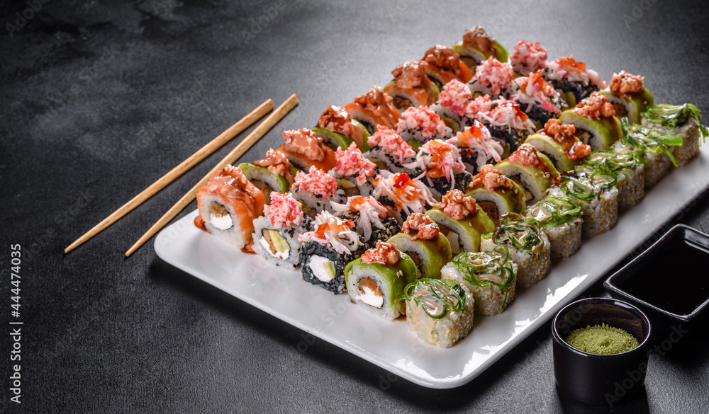 Delicious fresh rolls in various sets. Japanese food with avocado, shrimp, crab and salmon Delicious fresh rolls in various sets. Japanese food with avocado, shrimp, crab and salmon