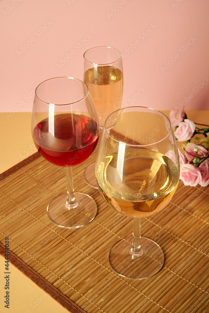 Three glasses of different shapes and containers for wine stand on a