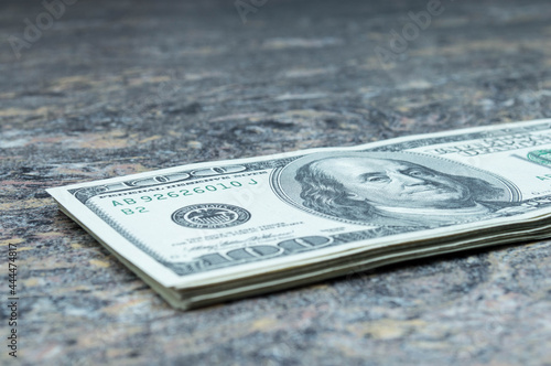 One hundred US dollars banknotes. Cash one hundred dollar bills, 100 dollars, Benjamin Franklin portrait, american currency exchange finance.