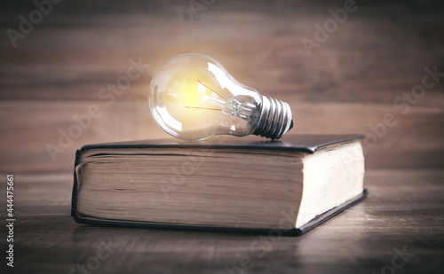 Light bulb and book. Knowledge and wisdom photo