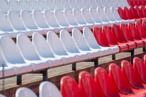 Red and white plastic seats in the stadium.