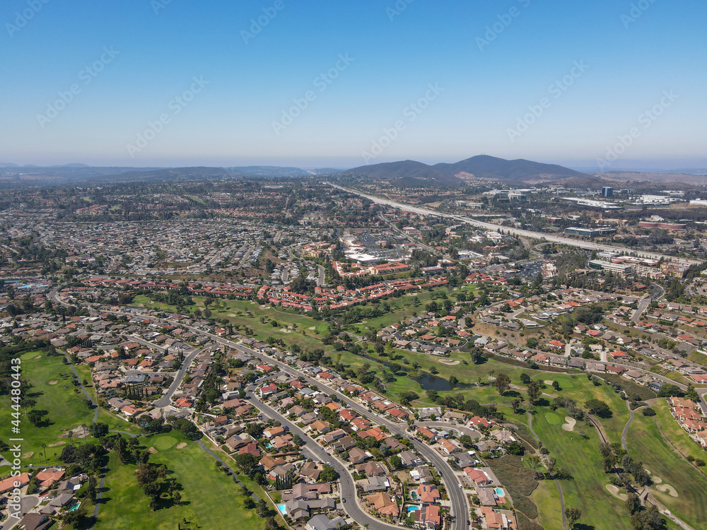 Aerial view of residential neighborhood surrounded by golf and valley during sunny day in Rancho Bernardo, San Diego County, California. USA. 