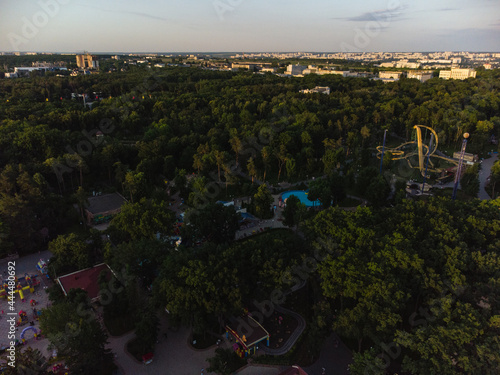 Attractions recreation area with greens in sunset light. Aerial evening view in Kharkiv city center Park of Maxim Gorky