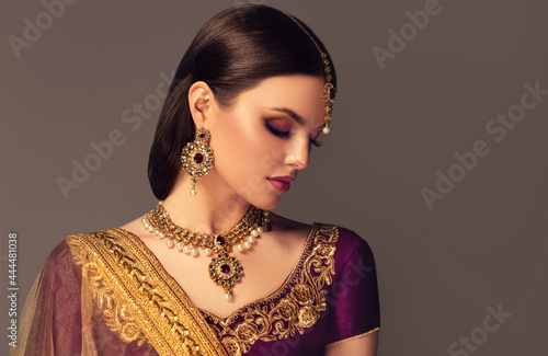 Portrait of beautiful indian girl. Young India woman model with kundan jewelry set. Traditional Indian costume lehenga choli or sari photo
