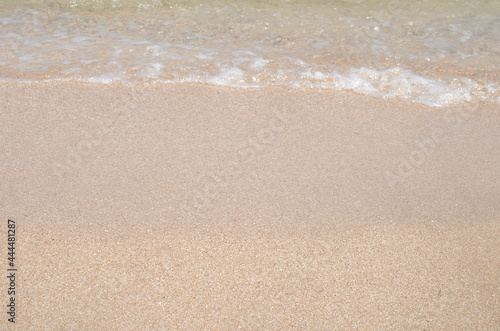 Fototapeta Naklejka Na Ścianę i Meble -  Sandy seashore with golden sand. Beautiful summer background. Design of a template, photo wallpapers, covers, screensavers.