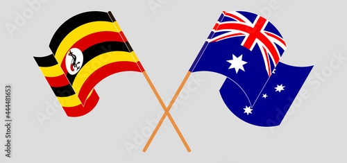 Crossed and waving flags of Uganda and Australia