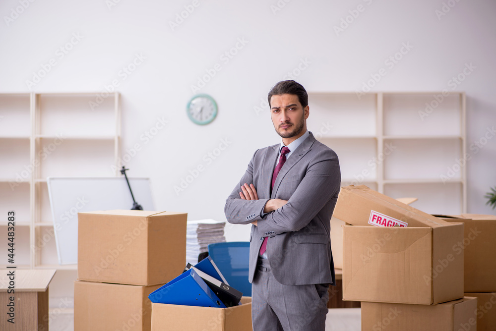 Young male employee in relocation concept Young male employee in relocation concept