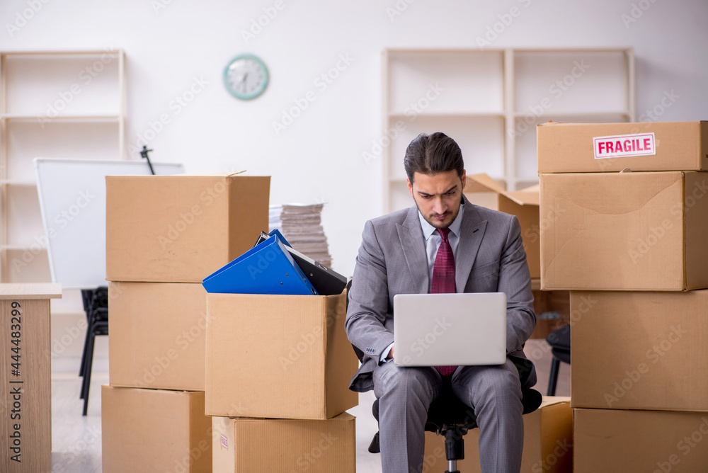 Young male employee in relocation concept Young male employee in relocation concept