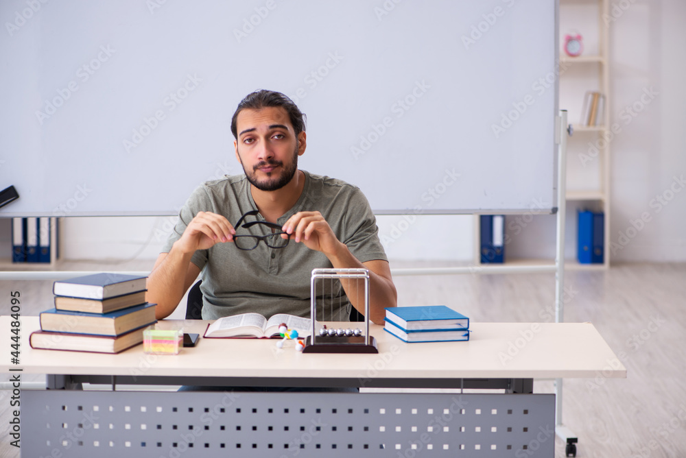 Young male student preparing for exams in the classroom Young male student preparing for exams in the classroom