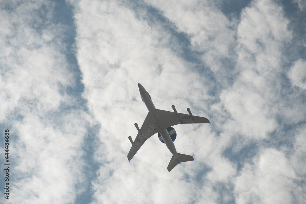 Lake Elsinore, California - June 10, 2021: United States Air Force AWACS jet flying directly overhead. Lake Elsinore, California - June 10, 2021: United States Air Force AWACS jet flying directly overhead.