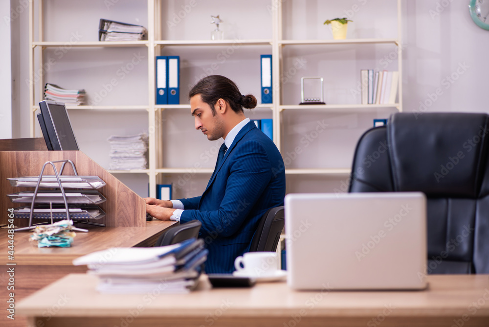Young male employee working in the office Young male employee working in the office
