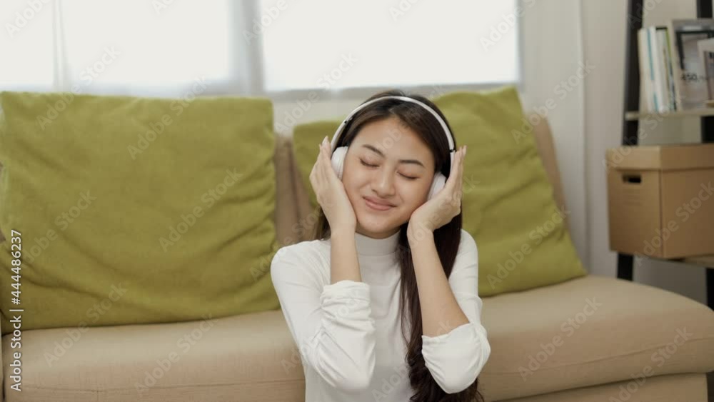 Relaxing time on sofa. Beautiful young asian woman lay down on sofa and listening to the music with headphone. She has rhythm Lifestyle in living room at house in the morning. Relaxing time on sofa. Beautiful young asian woman lay down on sofa and listening to the music with headphone. She has rhythm Lifestyle in living room at house in the morning.