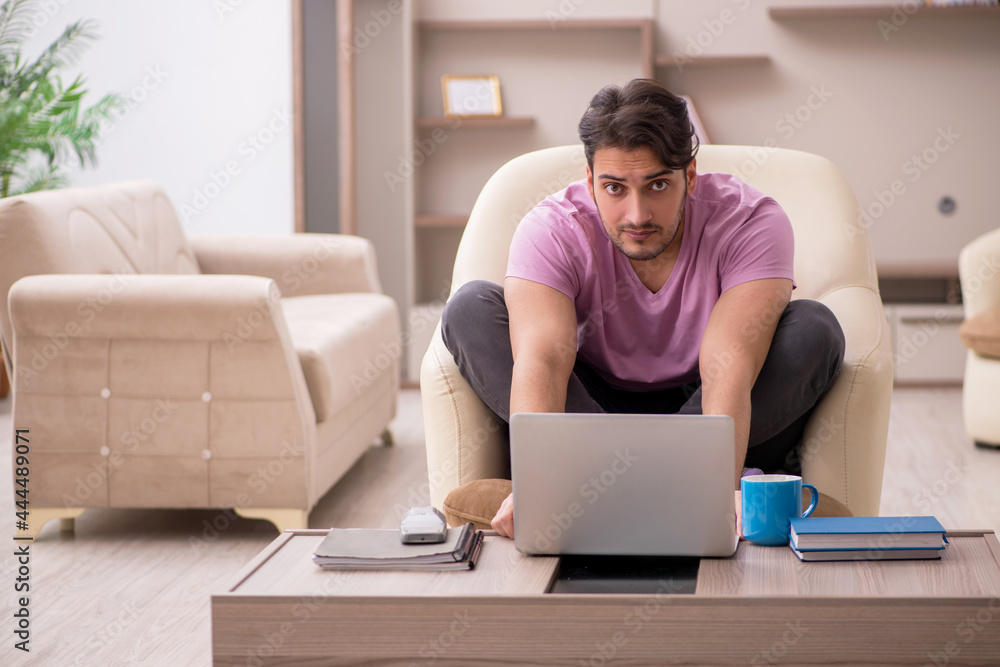 Young man working from home during pandemic Young man working from home during pandemic