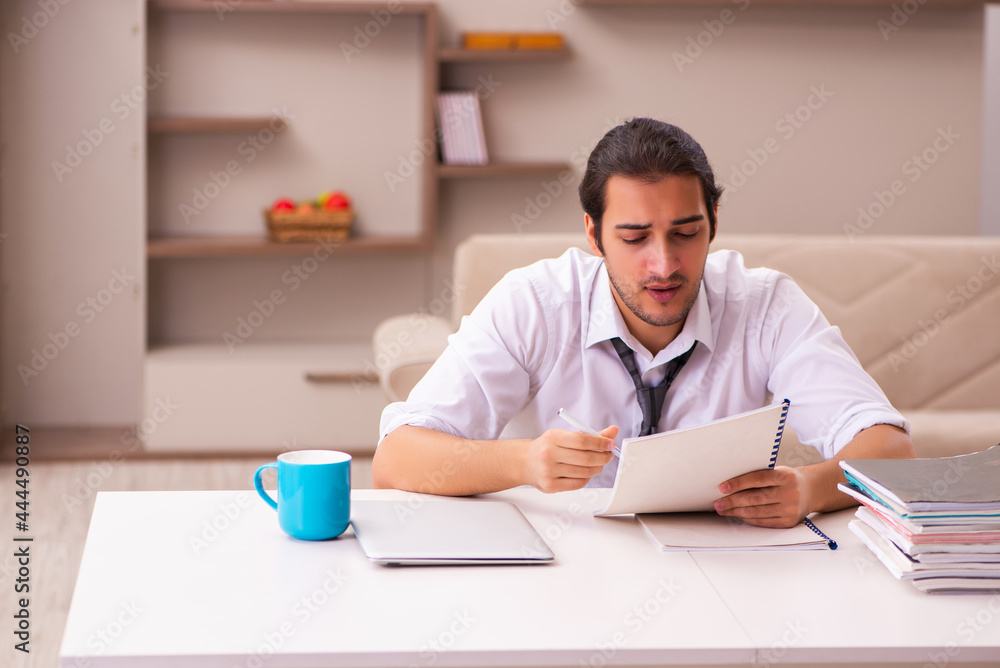 Young male employee working from home during pandemic
