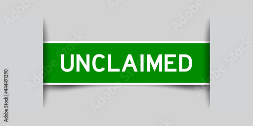 Label sticker green color in word unclaimed that inserted in gray background