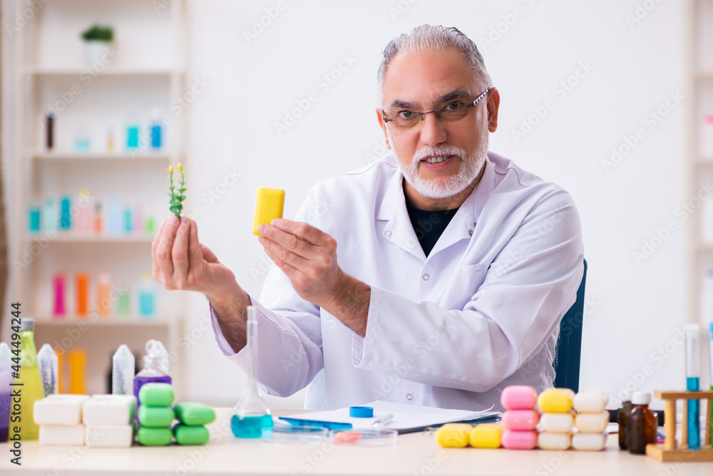 Old male chemist testing soap in the lab Old male chemist testing soap in the lab