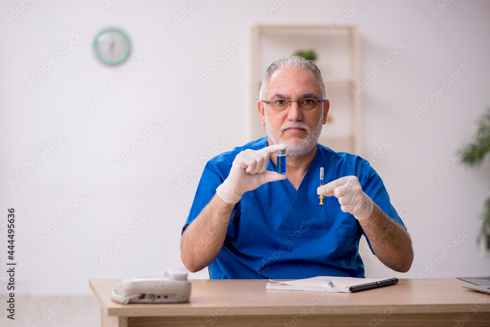 Fototapeta premium Old male doctor in vaccination concept