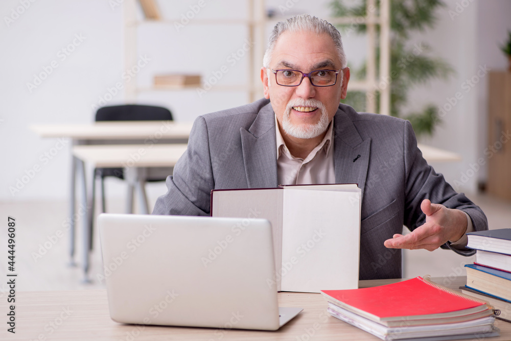 Aged male teacher in the classroom Aged male teacher in the classroom