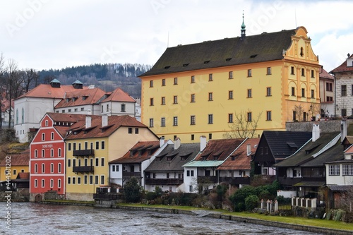 Yellow buildings on banks of Vltava River in historic center of Cesky Krumlov.