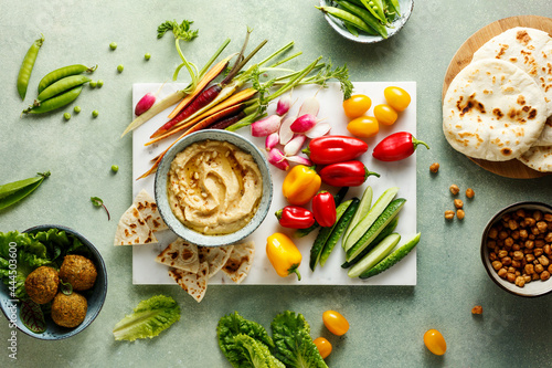 Homemade hummus with spices and pine nuts photo