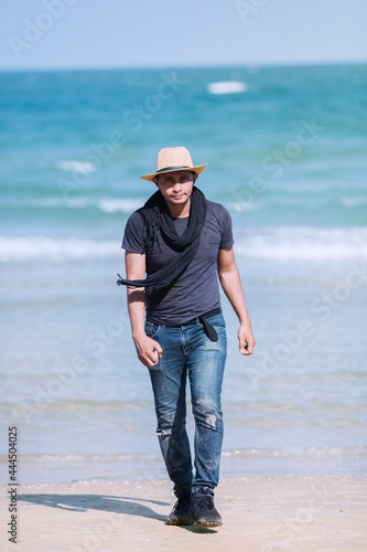 Attractive man walking in the middle of nature sea ​​and sand
