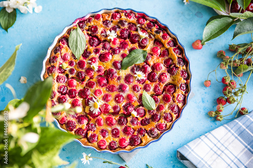 cherry Clafoutis with cherry on a blue  background photo