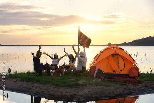 Group of young asian camper enjoy camping outdoors. Party.Camping of asian man and women group, Relaxing, Summer Hiking concept .