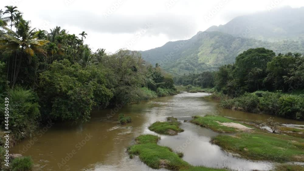 view of river with mountains covered by clouds view of river with mountains covered by clouds