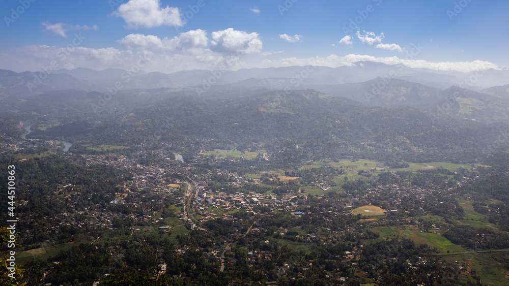 Panoramic view from Ambuluwawa tower, a distant misty mountain range with small towns and villages aerial view.