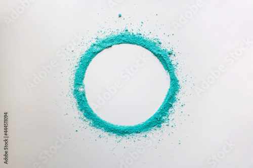 Turquoise colored powder circle frame on white background