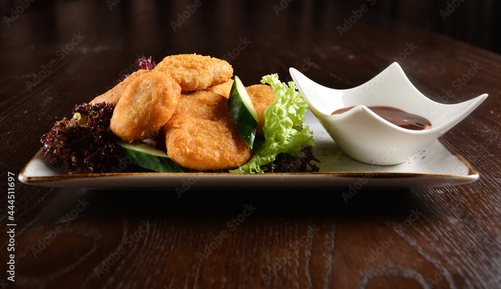 deep fried golden crispy chicken or fish nugget with homemade sauce on wood table snack Halal menu deep fried golden crispy chicken or fish nugget with homemade sauce on wood table snack Halal menu