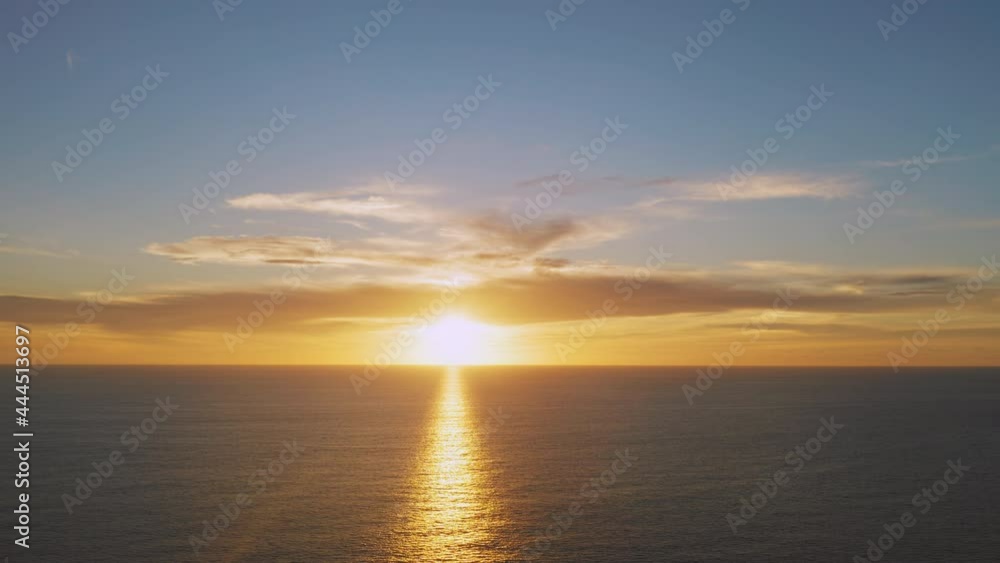 4K Aerial drone top view Beautiful sunset over the tropical beach with clouds In the middle of the sea. Romantic sunset sky over tropical beach holiday summer vacation concept. 4K Aerial drone top view Beautiful sunset over the tropical beach with clouds In the middle of the sea. Romantic sunset sky over tropical beach holiday summer vacation concept.