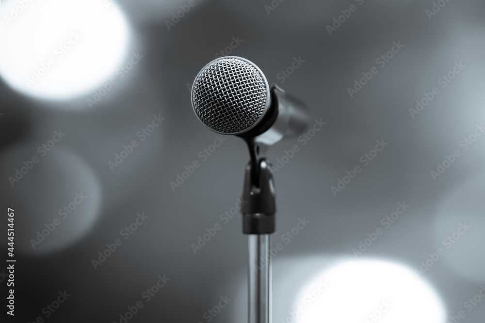 Microphone Public speaking backgrounds, Close-up the microphone on stand for speaker speech presentation stage performance with blur and bokeh light background. Microphone Public speaking backgrounds, Close-up the microphone on stand for speaker speech presentation stage performance with blur and bokeh light background.