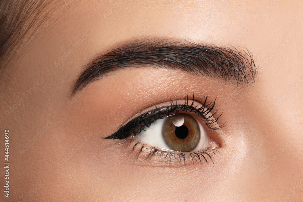 Obraz premium Beautiful woman with black eyeliner, closeup view