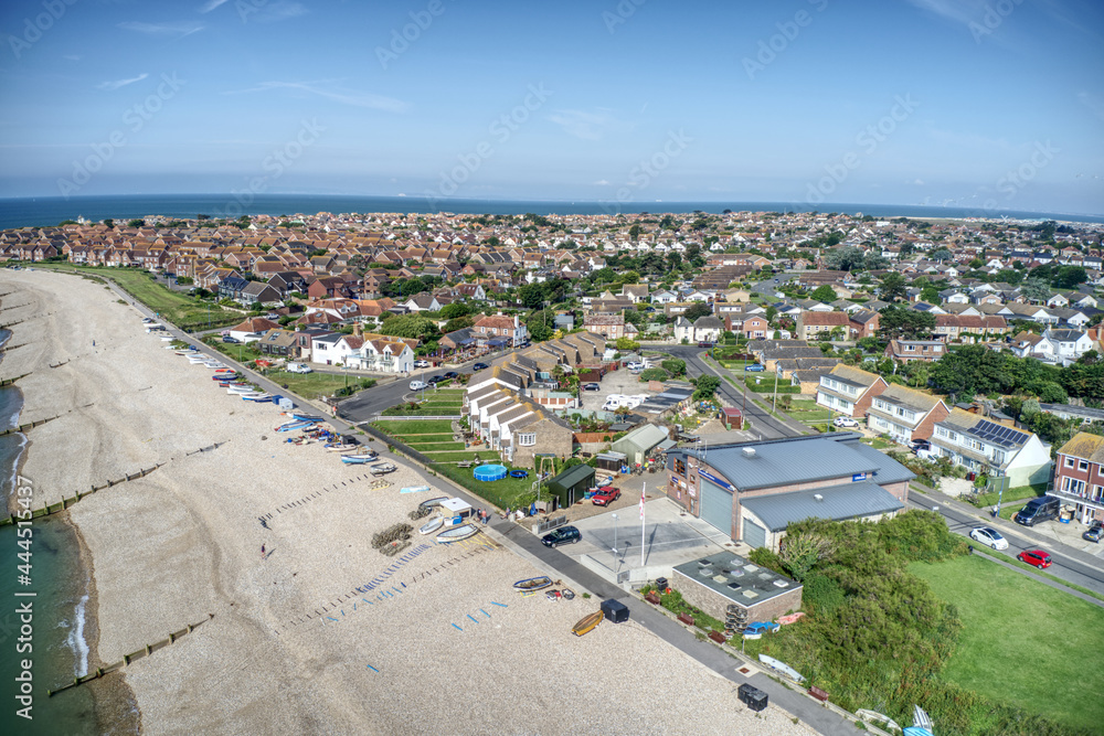 East Beach in Selsey West Sussex with small boats lined up on the wide shingle beach at this popular tourist destination. Aerial view.