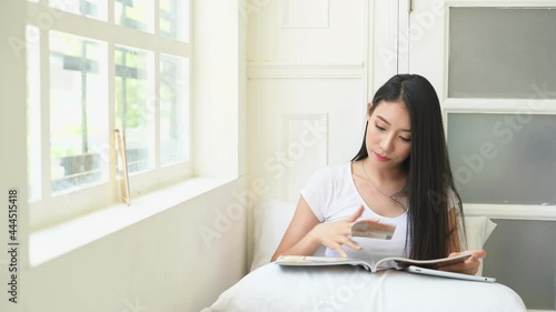woman working on laptop in bedroom on morning