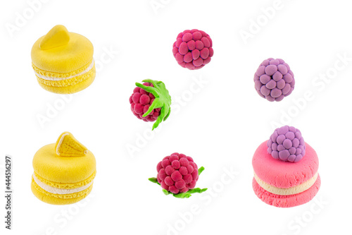 macaroons and berries molded from plasticine isolated on white background